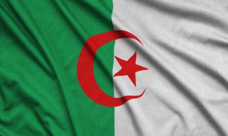 Algeria flag is depicted on a sports cloth fabric with many folds. Sport team waving banner