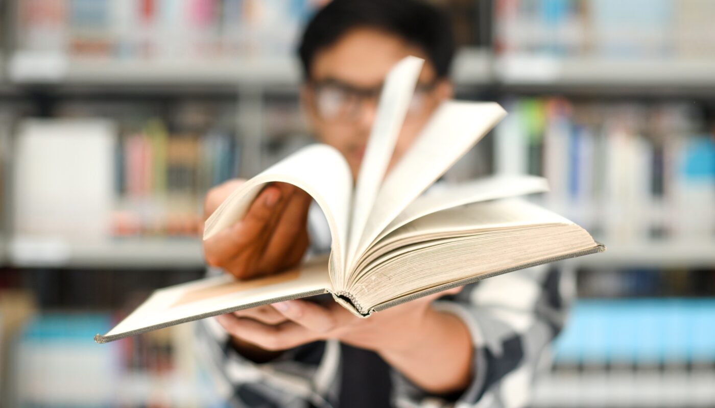 Close-up of hand flipping the book