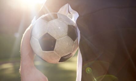 close up of soccer player with ball on field