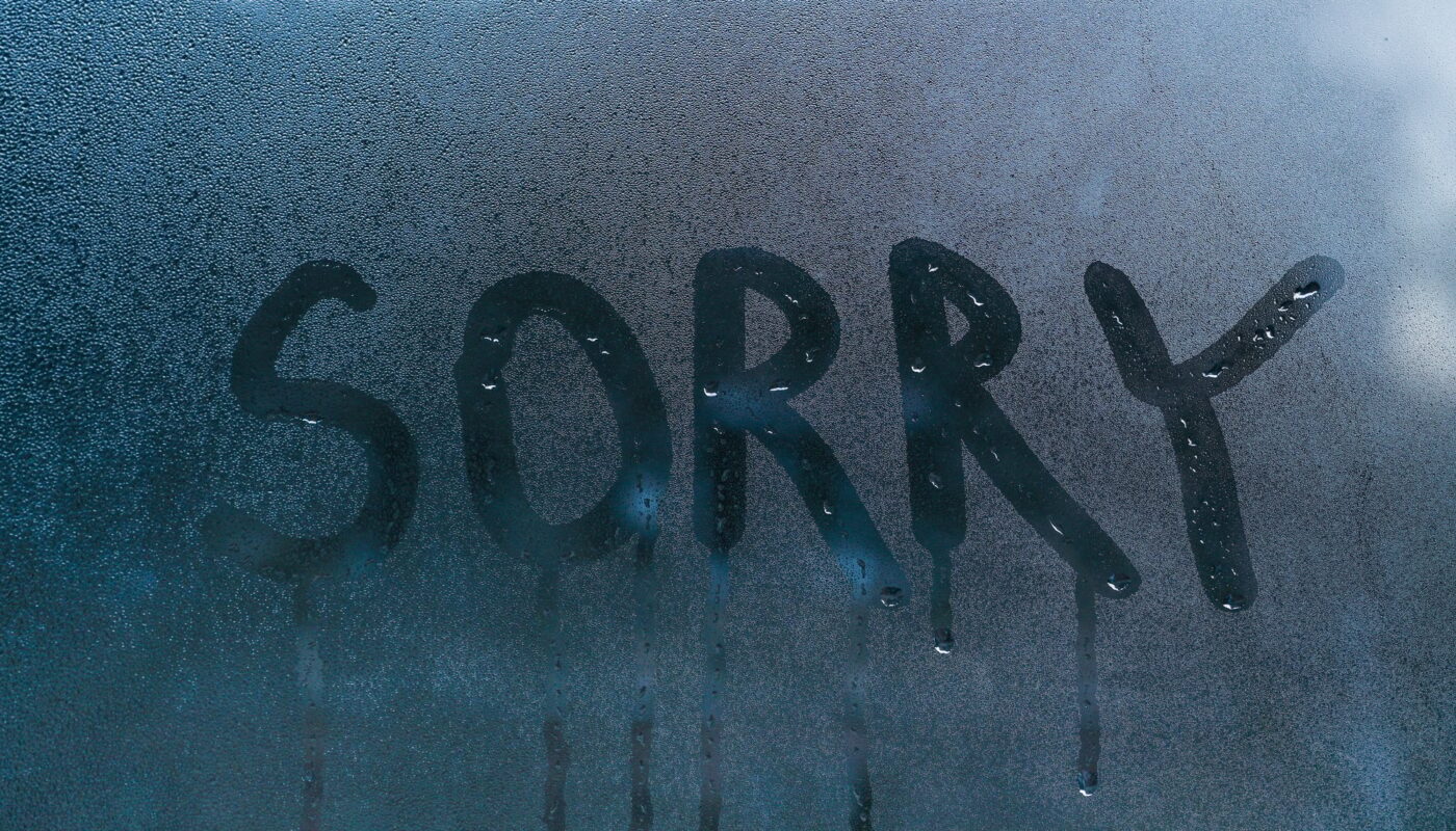 The word sorry on the wet glass.concept